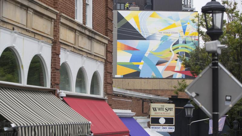 High above University Avenue, the mural is now visible from Grounds, adding a colorful  element to the tableau of art and architecture that UVA students and visitors enjoy each  day.