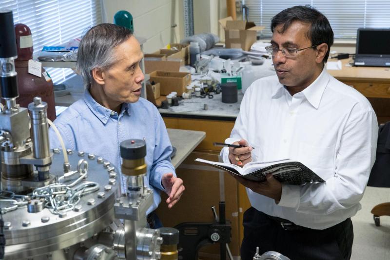 Joseph Poon, left, chair of the Department of Physics, and Avik Ghosh, a professor in the Department of Electrical and Computer Engineering and Department of Physics, discuss how to create skyrmions.