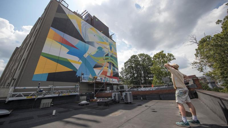 Guinn began painting the mural in June and gradually brought to life a colorful, abstract design intended to capture the optimism of Dove’s poem.