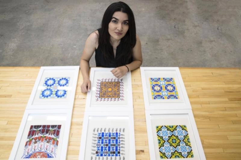 Feraidon with the paintings in her “Hide and Seek” series. She used photos of Afghan women to create some of the patterns seen here, including the borders of the two paintings in the middle row and the central figures of paintings in the first and third r