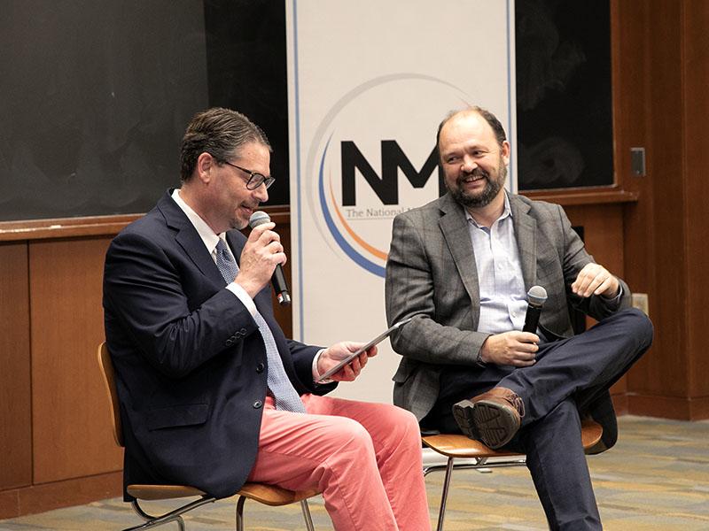 UVA professor Brad Wilcox and New York Times columnist Ross Douthat laughing together during a panel discussion.