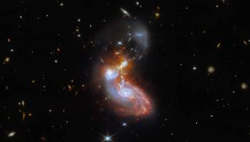 A merging galaxy pair cavort in this image captured by the James Webb Space Telescope, an international mission led by NASA with its partners ESA (European Space Agency) and CSA (Canadian Space Agency). This new Webb image of a pair of galaxies, known to astronomers as II ZW 96, was first previewed for Vice President Kamala Harris and French President Emmanuel Macron during a visit to NASA Headquarters in Washington Wednesday, Nov. 30. 