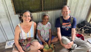UVA linguist Lise Dobrin and UVA Wise ethnobotanist Ryan Huish flank a village elder, Lusi Taramap, who helped the researchers understand the relationships among banana varieties. (Photo courtesy of Lise Dobrin and Ryan Huish)