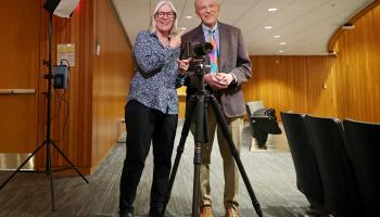 University Professor Ken Elzinga reunited with his former student, Nancy Andrews, when she returned to Grounds to take his portrait for the president’s office. 