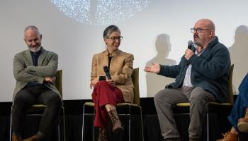 Three A&S faculty members sit on stage in discussion at the Global Spanish Initiative's closing event.