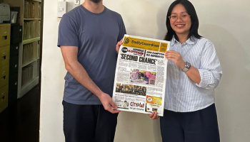 Spanish Ph.D. student Robert Sanchis-Álvarez and Center for West Visayan Studies director Frances Anthea R. Redison posing with the front page of a newspaper.