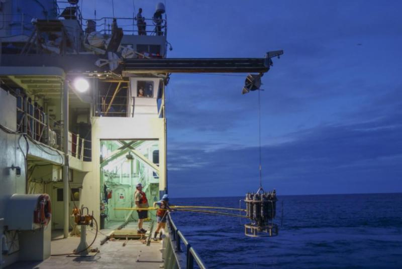 With the help of a marine technician, students retrieve samples of the waters of the South Atlantic for analysis. 