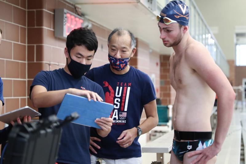 Professor Ono and swimmers discussing 