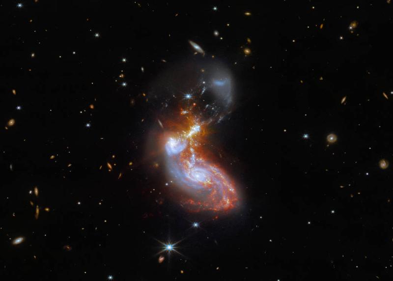 A merging galaxy pair cavort in this image captured by the James Webb Space Telescope, an international mission led by NASA with its partners ESA (European Space Agency) and CSA (Canadian Space Agency). This new Webb image of a pair of galaxies, known to astronomers as II ZW 96, was first previewed for Vice President Kamala Harris and French President Emmanuel Macron during a visit to NASA Headquarters in Washington Wednesday, Nov. 30. 