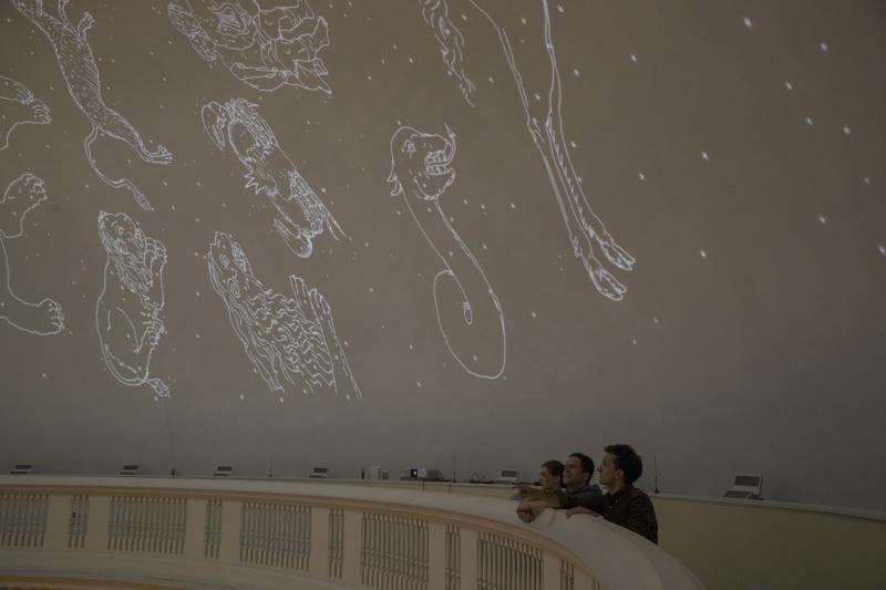 English Ph.D. candidates (from left) Madeline Zehnder, Neal Curtis and Samuel Lemley won a Jefferson Trust grant to recreate Jefferson’s idea for a Rotunda Planetarium. One of the projectors is visible in the center of the photo.