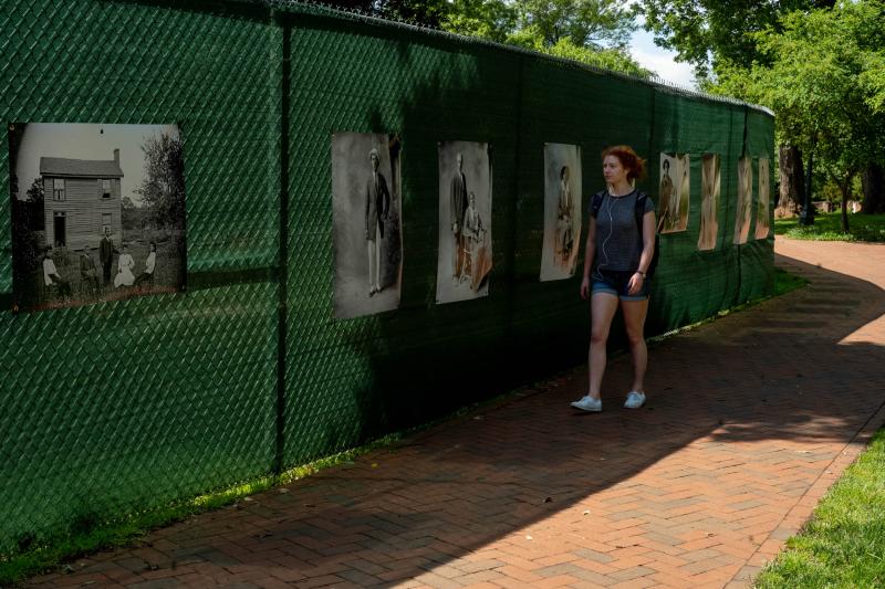 A student walks past the new display, which will remain up through the fall.