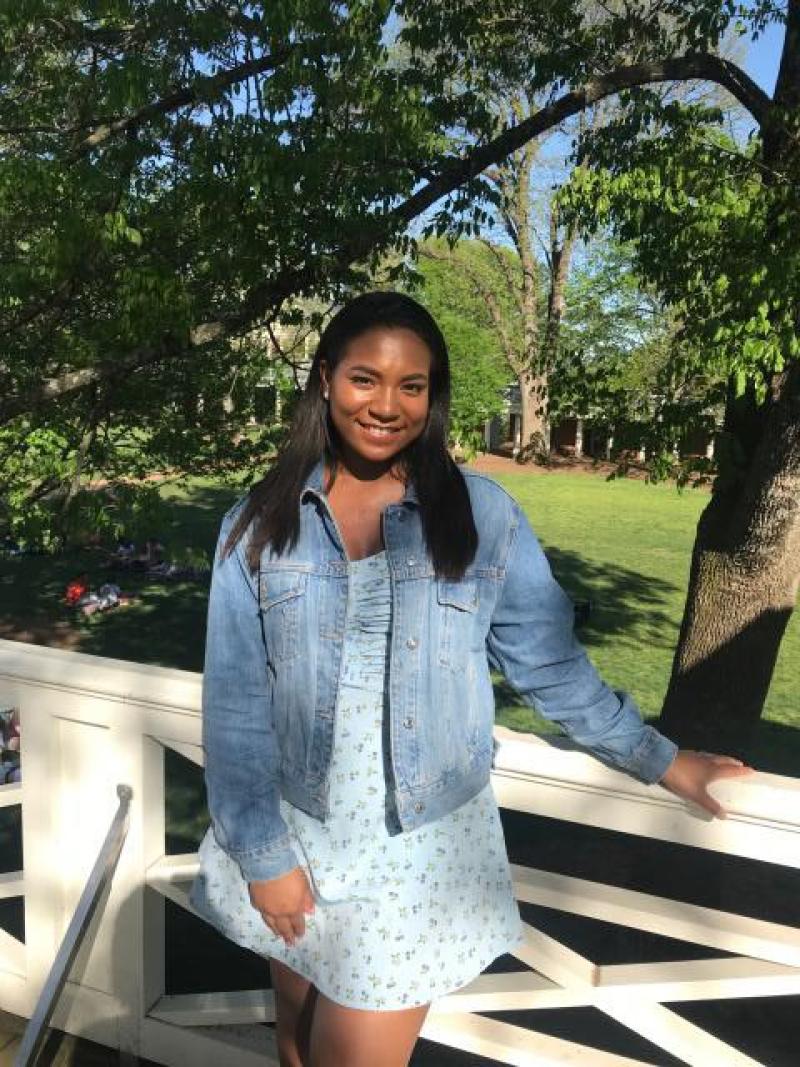 2020 graduate Sydney Williams on a Pavilion rooftop on the Lawn.