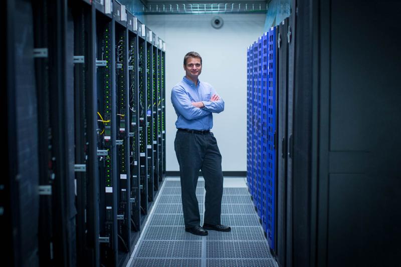 ITS computer engineer Adam Munro oversees the operation of the new computer cluster. The new system is expected to be a boon for “big data” and computationally intensive areas of astronomy, molecular modeling in pharmacology, atmospheric chemistry simulations, high-energy physics data sorting, genome modeling, ocean currents modeling, a range of engineering problems, data mining, and large-scale text analysis, among others.