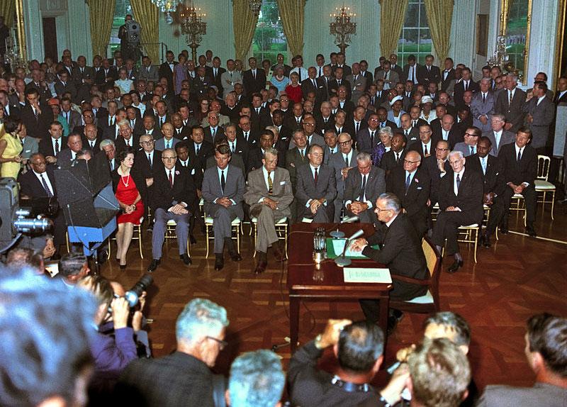 President Lyndon B. Johnson signs the Civil Rights Act in 1964