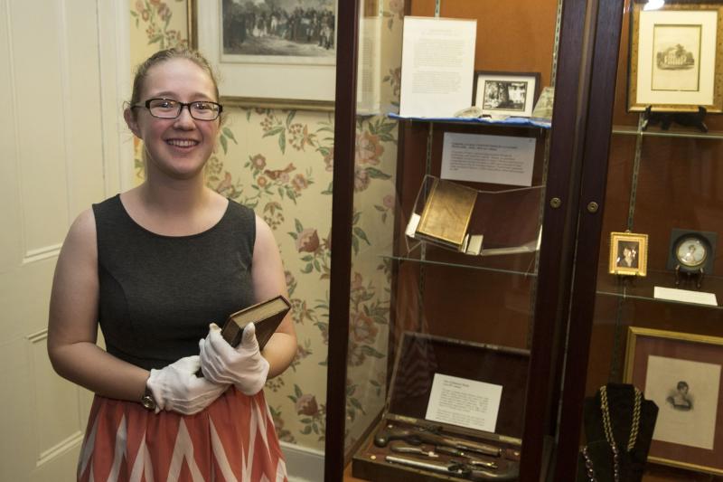 Ashley Spinks, fourth-Year History and Government major, holds a book originally owned by James Monroe