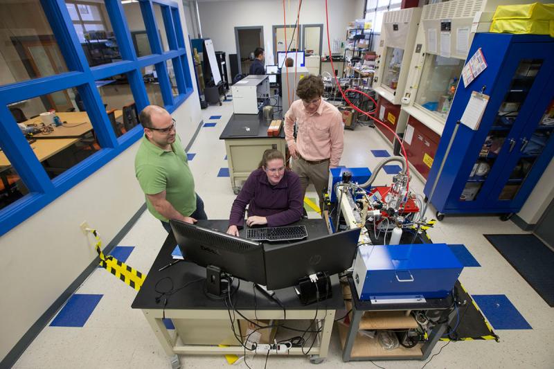 BrightSpec team members at work in the lab. From left to right: co-founder and UVA alumnus Matt Muckle, co-founder Robin Pulliam, and co-founder and UVA alumnus, Dave McDaniel.