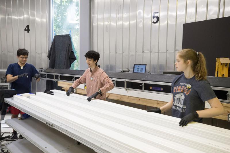Physics students Michael Stepniczka, William Musk and Hannah Woodward select detectors to build a module.