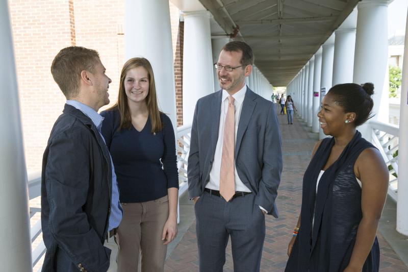 Ian Baucom, Dean of the College and Graduate School of Arts & Sciences, with students on the Bryan Hall walkway