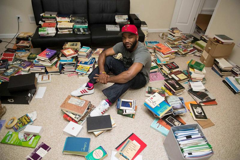 Carson in his new home in Charlottesville, amongst the extensive collection of books he relies on as he writes new songs.