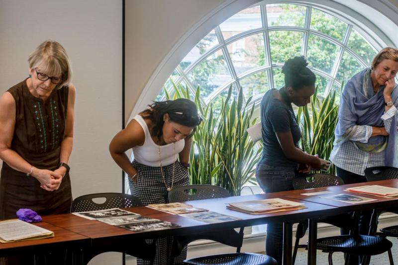 Visitors to the Albert and Shirley Small Special Collections Library examine photos and family correspondence from UVA’s collection of Julian Bond’s papers.