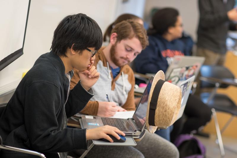 Thuy Vuong, seated in his class at UVA, is taking the course with his brother, Huan, who is a member of The Tribe.