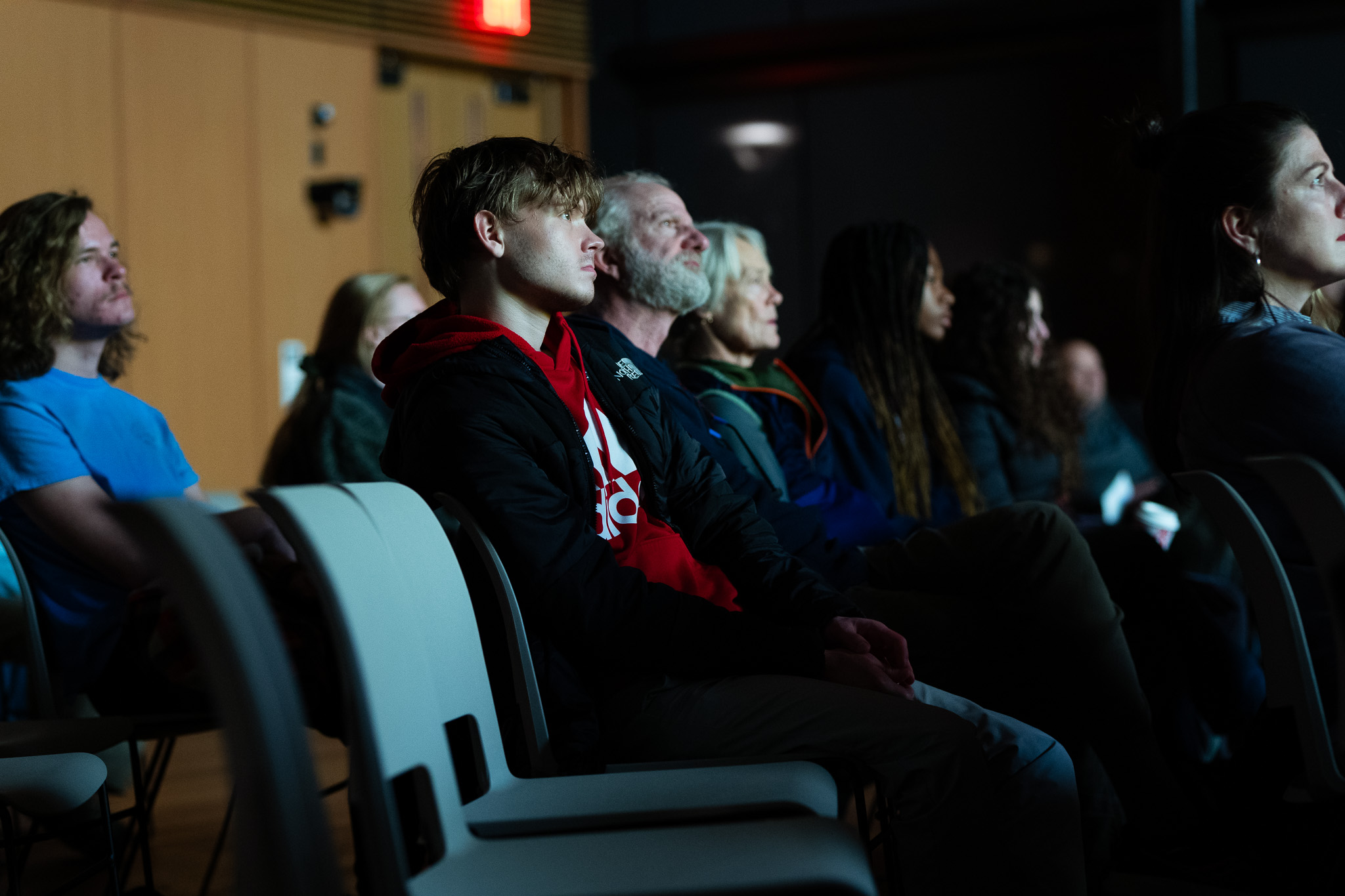 From the back row, audience members at a recent Enabling Difficulty Conversations event watch a film.