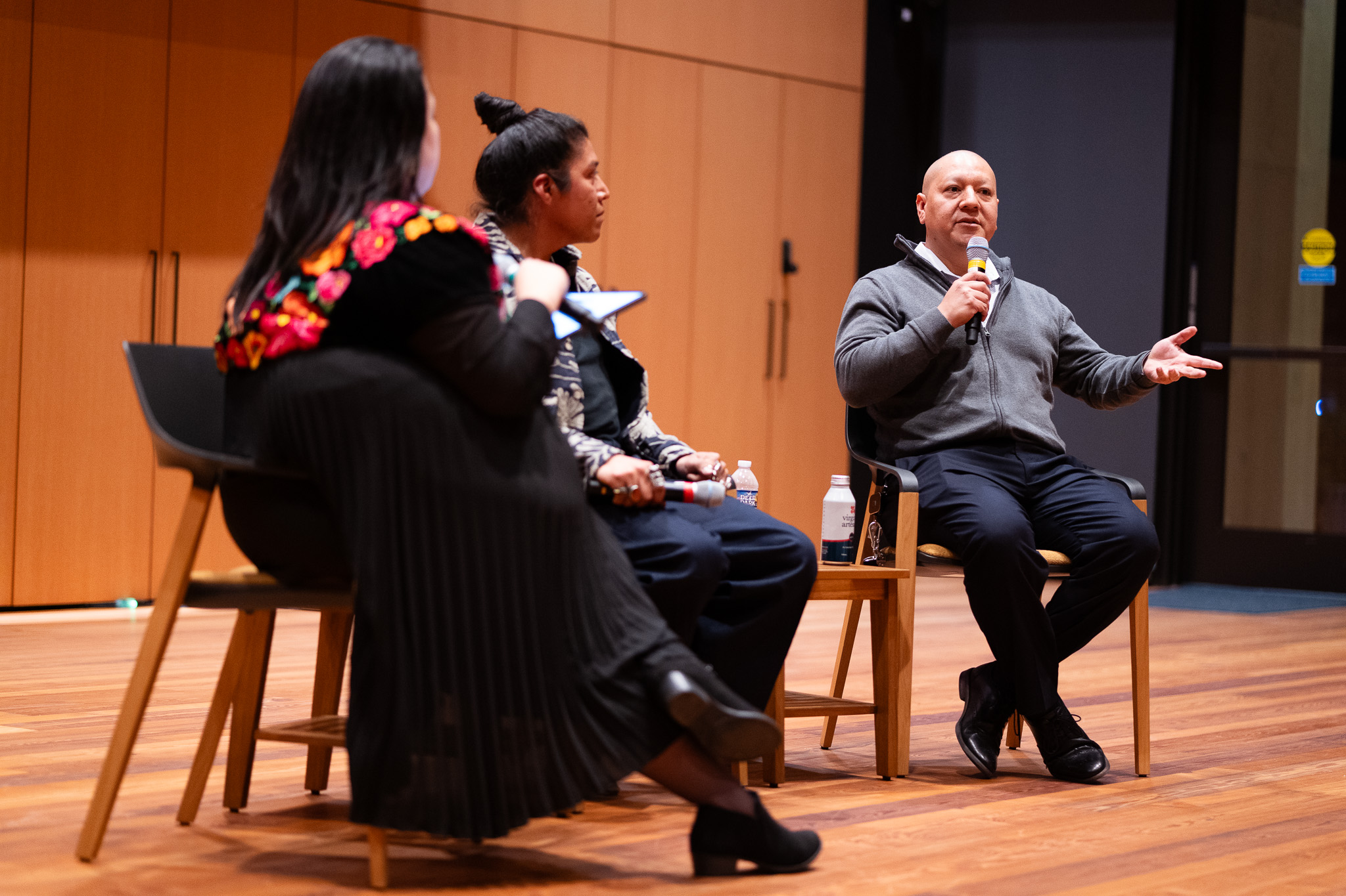 UVA Tribal Liaison Kody Grant speaks with hand outstretched during panel discussion.