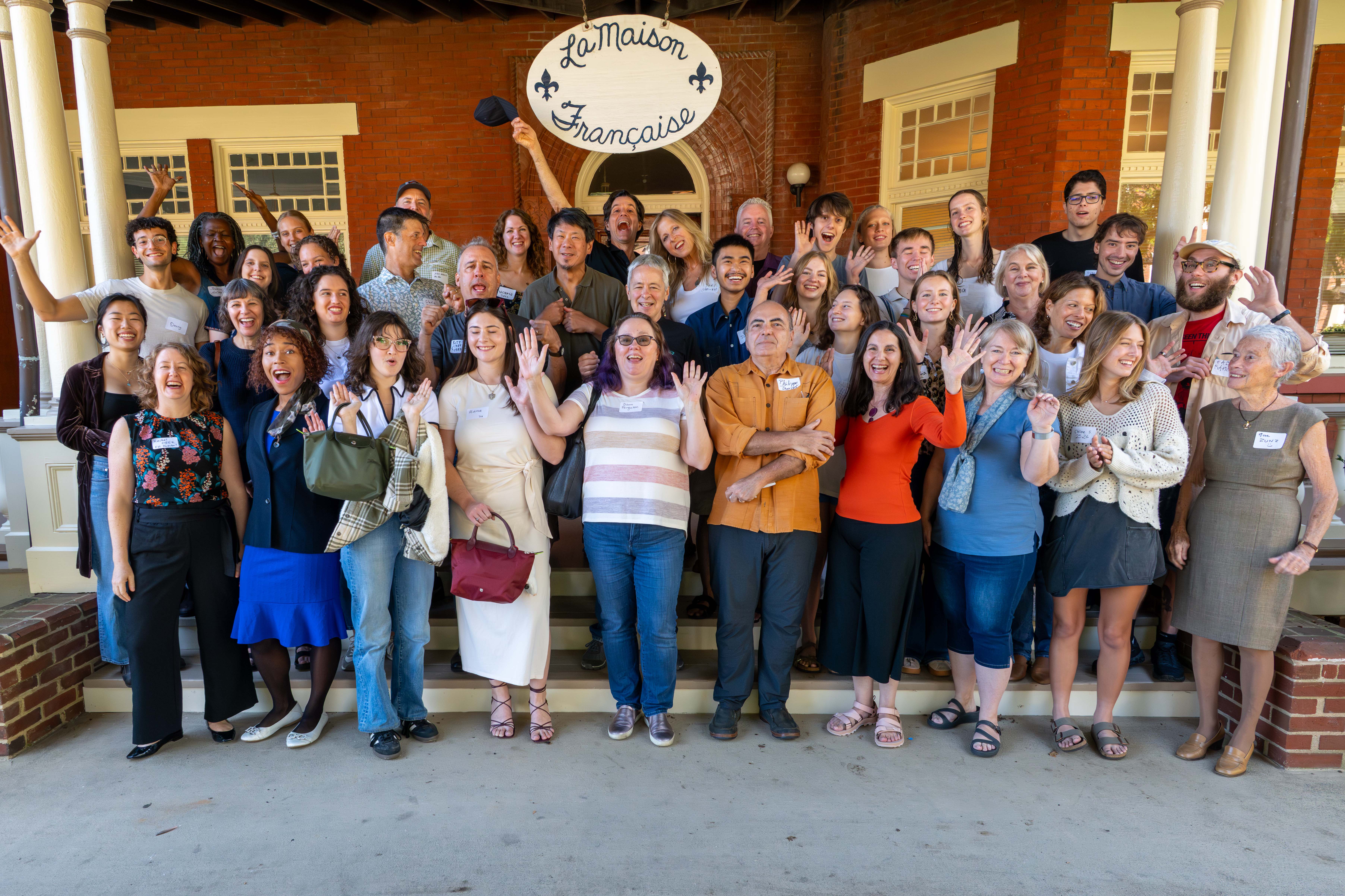 Group photo of former residents of UVA's French House, on the front steps.