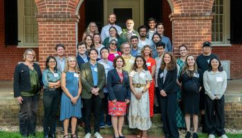 A group of new A&S faculty members pose for a group photo with A&S Dean Christa Acampora.