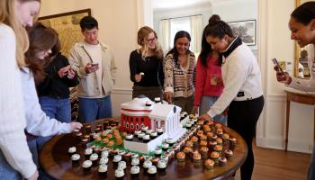 Students celebrating with a Rotunda cake and cupcakes on Carr's Hill